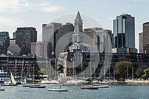 Yacht and sailing boats on Charles River in front of Boston Skyline in Massachusetts USA on a sunny summer day