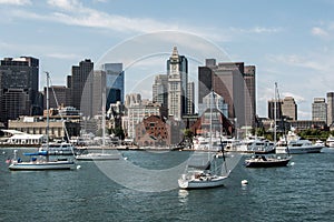 Yacht and sailing boats on Charles River in front of Boston Skyline in Massachusetts USA on a sunny summer day