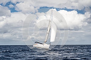 Yacht sailing fast on sea with waves in Italy, Mediterranean