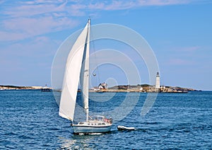 Yacht Sailing in front of Boston Harbor Lighthouse