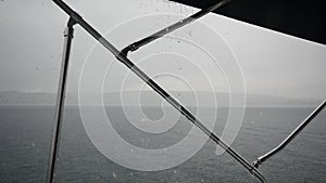 Yacht sailing in the rain on background of sea in Greece.