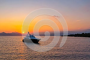 Yacht sailing on the sea with a beautiful sky in the background at sunset