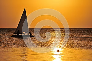 Yacht sailing at sunset