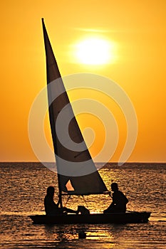 Yacht sailing at sunset photo