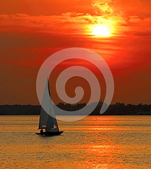 Yacht sailing into sunset