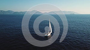 Yacht sailing in the wind . Side view. Taken from a drone