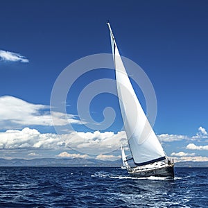 Yacht sails with beautiful cloudless sky. Sailing.