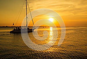 The yacht sails to the pier. Sea sunset time