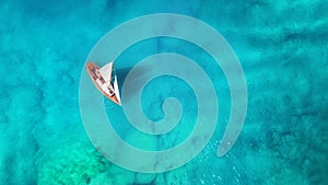 Yacht on the sea from top view. Turquoise water background from top view. Summer seascape from air.