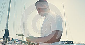 Yacht, tablet and captain with black man on pier for cruise, management and travel. Boat crew, network and digital with