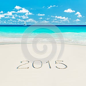 Yacht at tropical beach and 2015 happy new year sandy caption. S