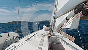 A yacht under sail rushes through the water on a sunny summer day in the Adriatic Sea