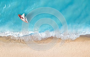 Yacht on the water surface from top view. Turquoise water background from top view.