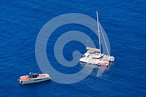 Yacht on the water surface from top view. Turquoise water background from top view. Summer seascape from air.