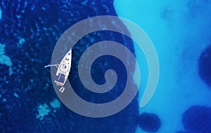 Yacht on the water surface from top view. Turquoise water background from top view. Summer seascape from air. Croatia.