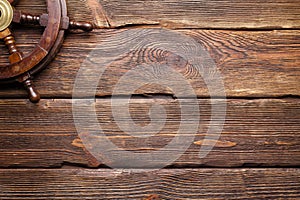 Yachting background - ship`s steering wheel on wooden table