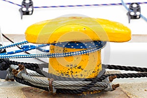 Yachting, colorful rope and yellow mooring bollard