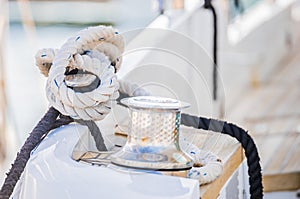 Nautical background, ropes tied on cleat of boat deck at marina