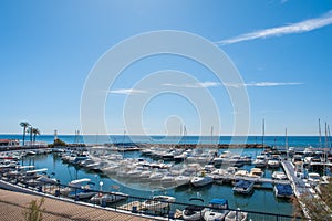 Yachting port with fishing boats and sport yachts in the Mediterranean Sea on a summer day