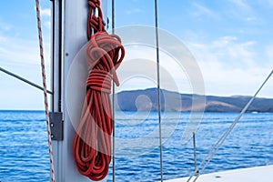 Yachting ropes on the sailing boat mast, blur sea water background