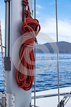 Yachting ropes on the sailing boat mast, blur sea water background