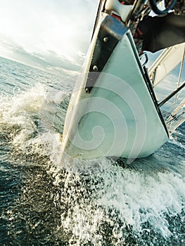 Yachting on sail boat bow stern shot splashing water
