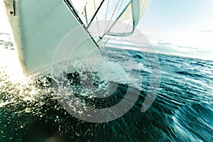 Yachting on sail boat bow stern shot splashing water