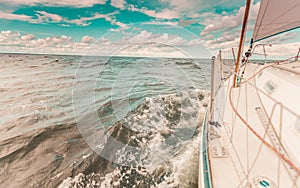 Yachting on sail boat bow stern shot splashing water