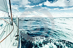 Yachting on sail boat bow stern shot splashing water