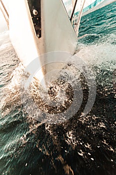 Yachting on sail boat bow stern shot splashing water