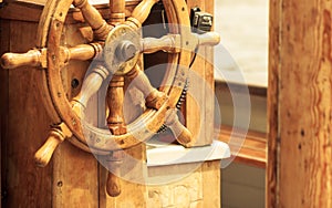 Yachting. Ship wooden steering wheel. Sailboat detail.