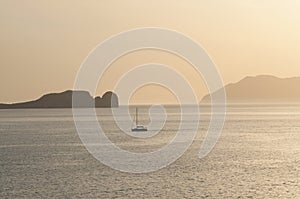 Yachting at sunset time near the coast of Milos island in Greece