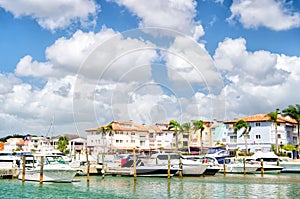 Yachts in bay with cloudy sky