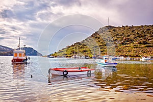 Yachts and boats anchored over the calm sea at gumusluk bay