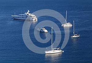 Yachts and boats in crystal clear azure water at Paleokastritsa. Corfu island, Greece.