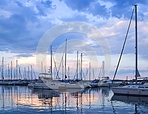 Yachts and boats in harbour at sunset