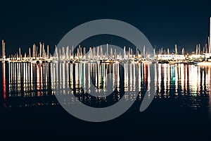 Yachts and boats in marina of La Spezia at night with reflection