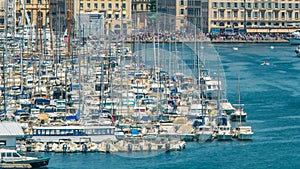 Yachts and boats moored in Old Port of Marseille, timelapse of moving vessels