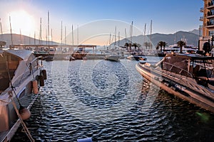 Yachts, boats and parachute in the bay of the city of Budva, Montenegro, the Balkans, the Adriatic Sea. Mountains and clouds.