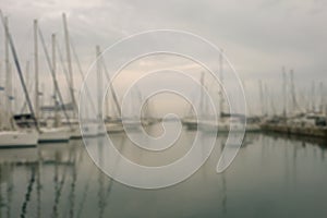 Yachts and boats are at the pier in the morning in the fog. Soft focus.