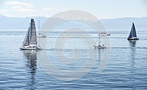 Yachts and catamarans in sailing races in sunny summer day. regatta is starting: sailboats go away to the Pacific ocean. Victoria