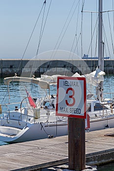 Yachts in coast marine around sign of speed limite photo