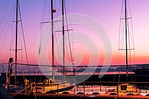 Yachts docked in the bay at sunset