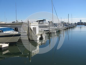 Yachts docked at pier