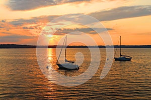 Yachts drifting on the lake during beautiful summer sunset