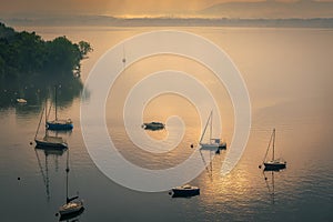 Yachts in the early morning mist at Lesa Lake Maggiore Piedmont