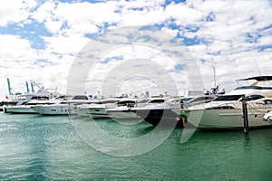 Yachts in miami marina bay at south beach with cloudy sky
