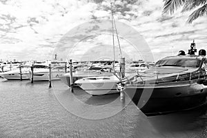 Yachts in miami marina bay at south beach with cloudy sky