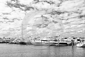 Yachts in miami marina bay at south beach with cloudy sky