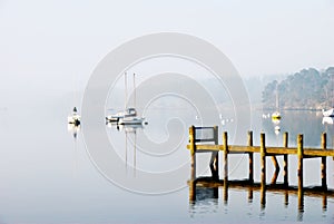 Yachts moored on a misty lake